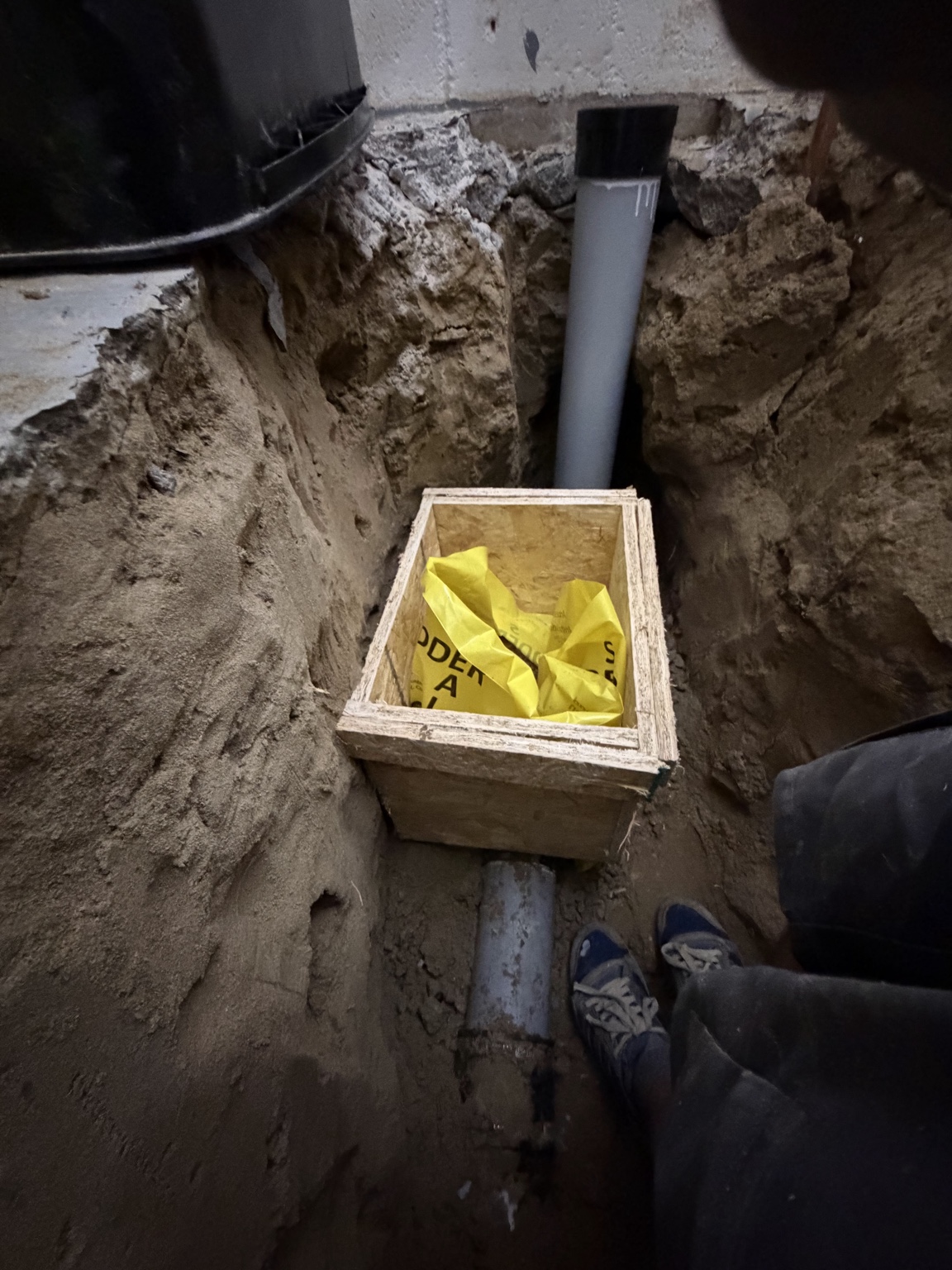 Excavation and underground drainage preparation for backwater valve installation